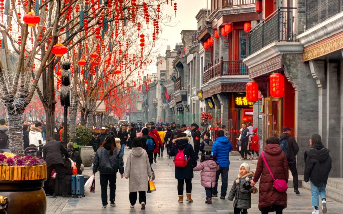 Chinese people walking through Qianmen district, Beijing, China